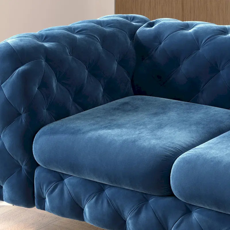 Causeuse chesterfield en velours capitonné