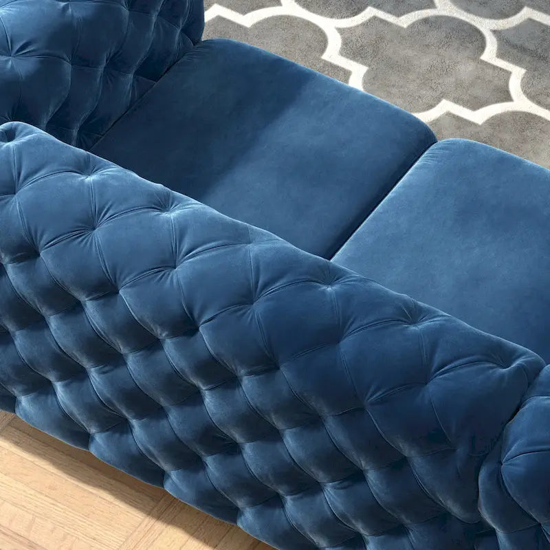 Causeuse chesterfield en velours capitonné