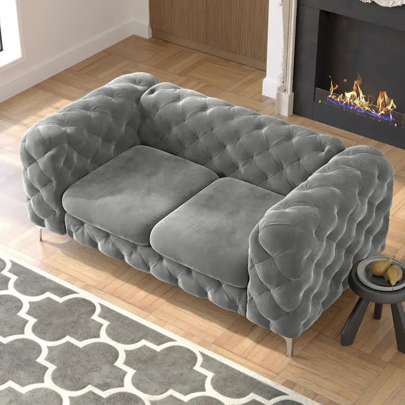 Causeuse chesterfield en velours capitonné