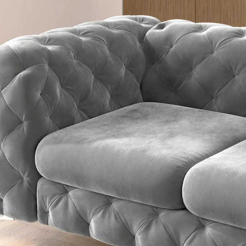 Causeuse chesterfield en velours capitonné