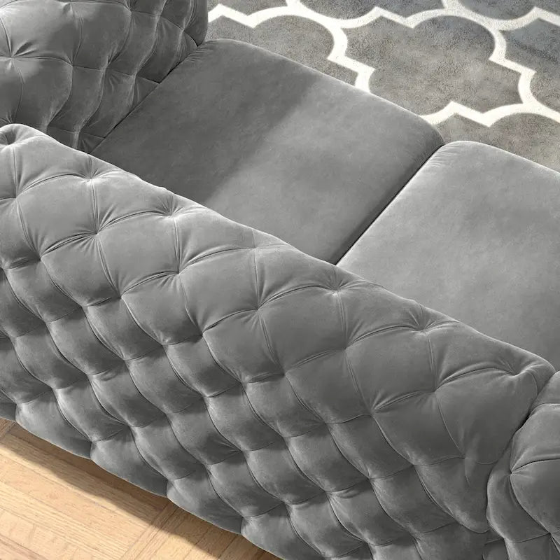 Causeuse chesterfield en velours capitonné